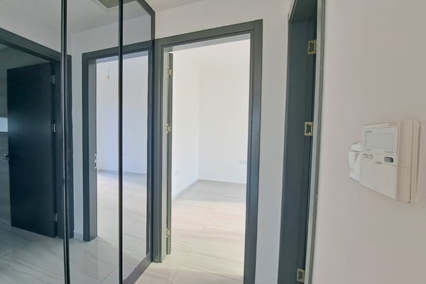 Corridor and doorway view reinforcing the home’s clean lines, modern materials, and cohesive interior language.