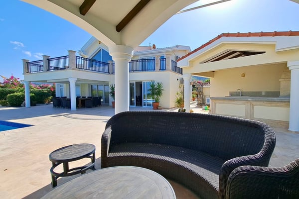 Classical pergola lounge framed by barrel-tile roof and soft LED lighting, offering stylish retreat throughout the day and evening.