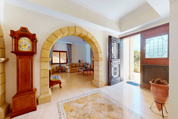 Interior hallway with a traditional grandfather clock and bright, airy atmosphere.