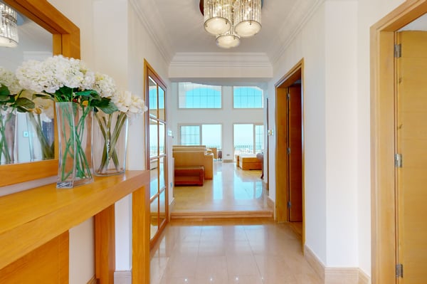 A stylish wooden staircase with elegant lighting, connecting the different floors of the villa in a seamless flow.