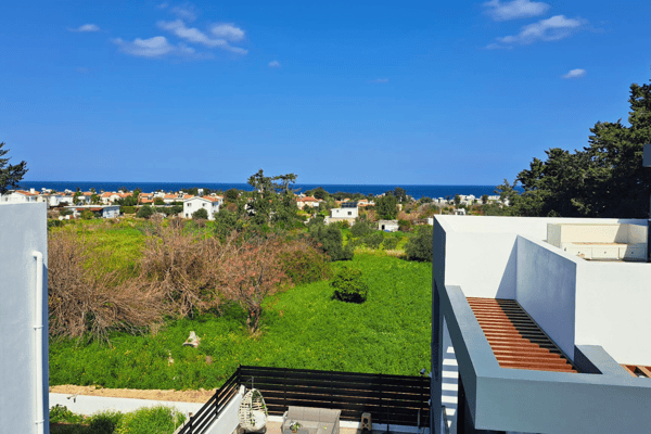 Garden view from the terrace overlooking lush greenery and lowland scenery.