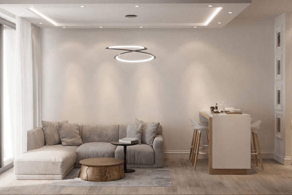 Relax in this inviting apartment living area featuring a comfortable sofa arrangement, accent chair, rug, and large windows for a bright atmosphere.