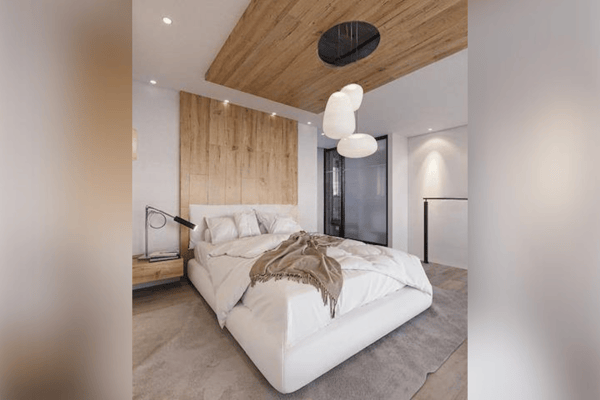 Second bedroom angle showing textured walls and warm lighting that enhance the comfort-focused atmosphere.