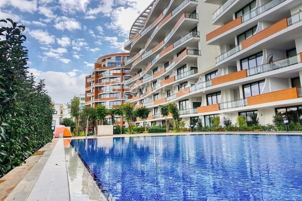 Discover a serene lifestyle in this apartment featuring elegant open-plan design, resort-style pools, and private green spaces.