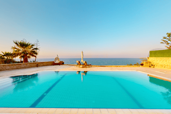 Breathtaking infinity-edge pool view, seamlessly blending with the sea beyond—pure visual serenity.