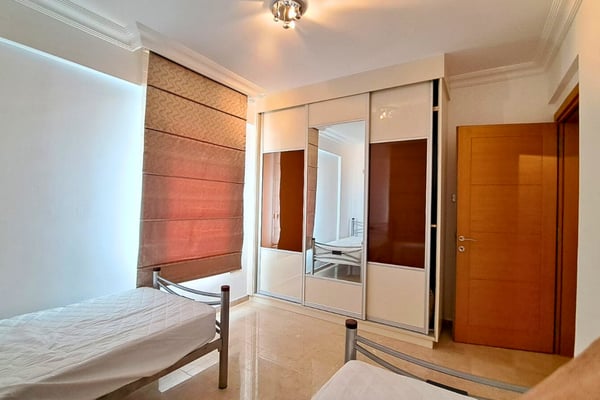 Dressing room with spotlight and symmetrical wardrobes, styled with boutique sensibility for organized living.