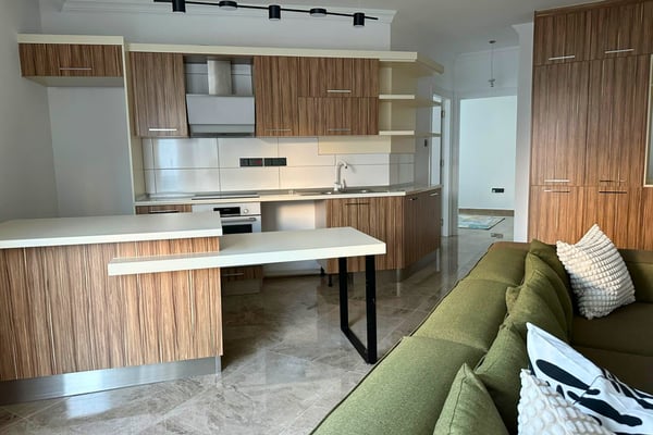 Modern kitchen with sleek cabinetry and light tones, offering a clean, practical space that blends seamlessly into the living area.