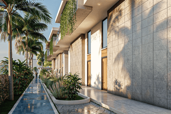 Walkway flanked by marble-inspired flooring, tropical plants, and residential buildings designed with symmetry in mind.