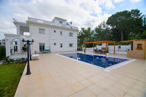 Tranquil poolside area with spacious terrace and integrated social zones perfect for serene outdoor gatherings.