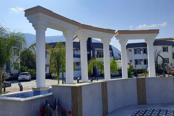 Entrance view of the apartment complex, emphasizing security and accessibility.