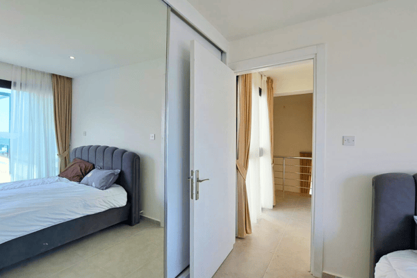 Simple bedroom design with integrated en-suite, showcasing functional elegance and natural brightness.