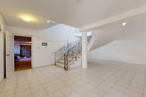 An inviting living and dining space with panoramic views of the lush garden, designed for comfort and relaxation.