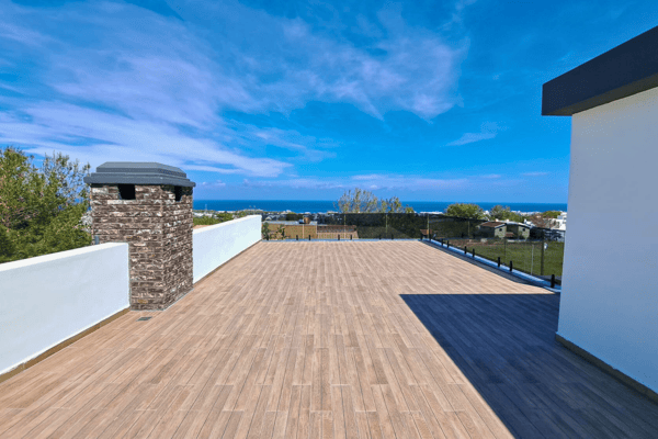 Spacious rooftop terrace with dual BBQ stations and elegant wood decking.