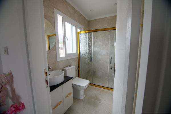 Elegant en-suite bathroom with premium fixtures and sleek tiling for a serene daily routine.