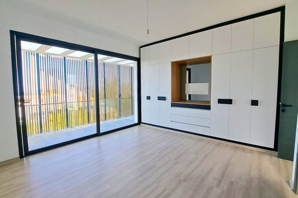 Master suite with clean lines, abundant daylight, and neutral tones, creating a peaceful, bright bedroom environment.