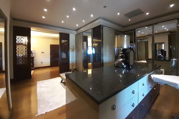 Formal Dining Room with Grand Chandelier – A luxurious dining space boasting a large table with multiple chairs, a stunning chandelier, floor-to-ceiling windows or doors, and ornate ceiling molding.