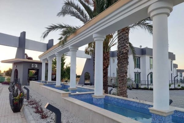 Under the moonlit sky, the illuminated pool sets the perfect ambiance for a peaceful evening retreat.