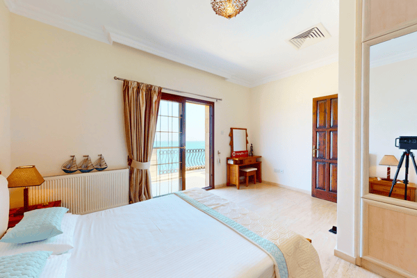 Bright double bedroom with terrace access and streamlined furniture.