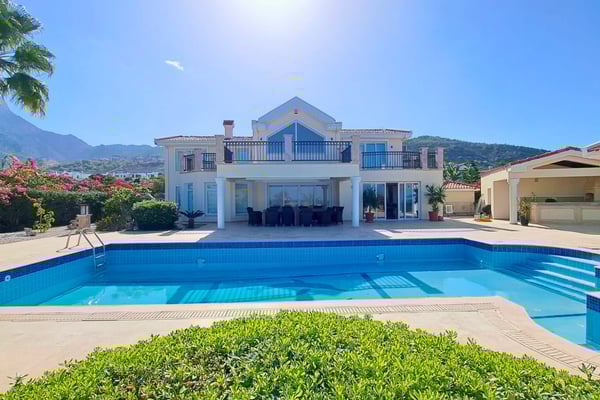 Discover this elevated villa in North Cyprus with panoramic Mediterranean views, lush gardens, and luxury resort features—ideal for year-round living or holiday escape.