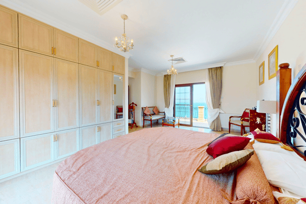 Master bedroom with extensive built-in storage and tasteful minimalist decor.