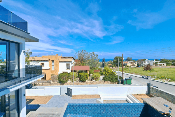 Bird’s eye view of the pool and rear garden area from an upper floor balcony.