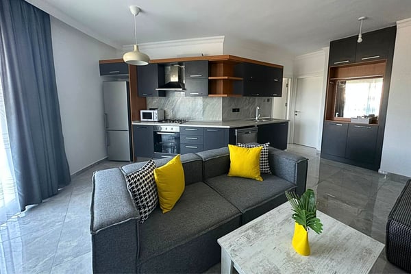 Contemporary dining space with sleek furniture and a well-integrated open-plan kitchen.