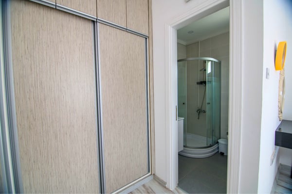 Guest suite featuring built-in wardrobe and direct bathroom access for comfort and practicality.