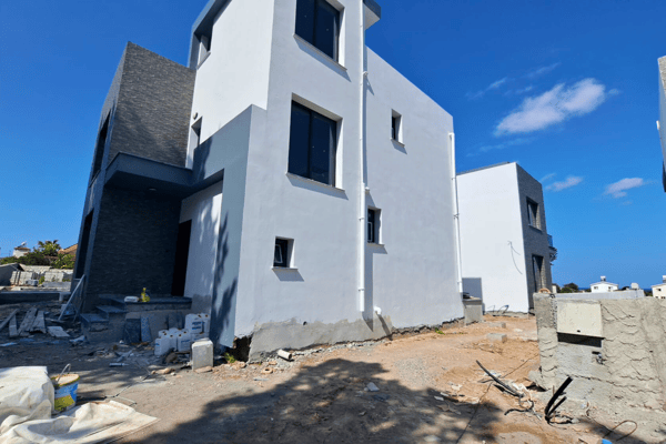 Neighboring house under construction, illustrating ongoing development in the area.