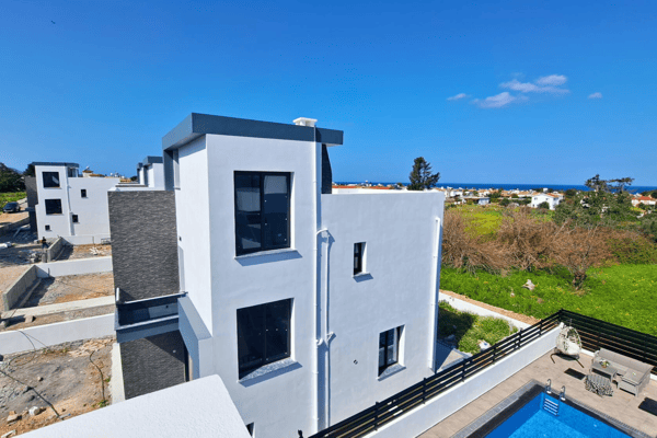 Corner angle showing architectural depth, second-floor balcony, and poolside layout.
