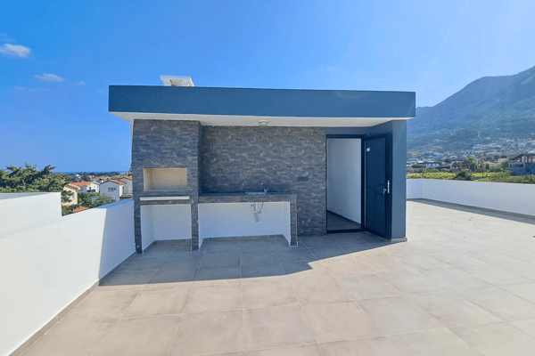 Outdoor grill area and kitchenette setup on the rooftop terrace.