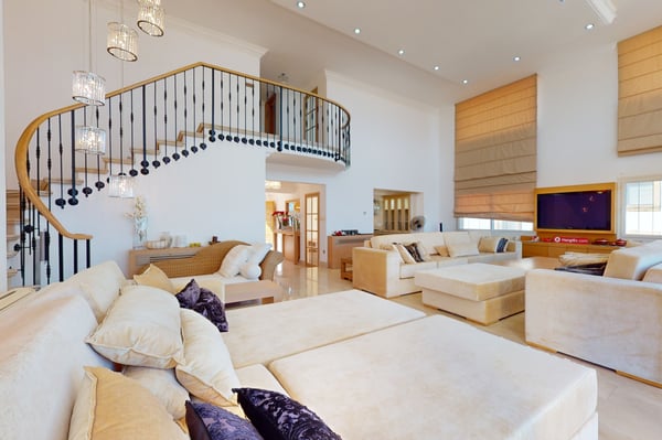 Bright and modern bedroom with a king-size bed, wooden furnishings, and large windows that offer a panoramic view of the surrounding landscape.