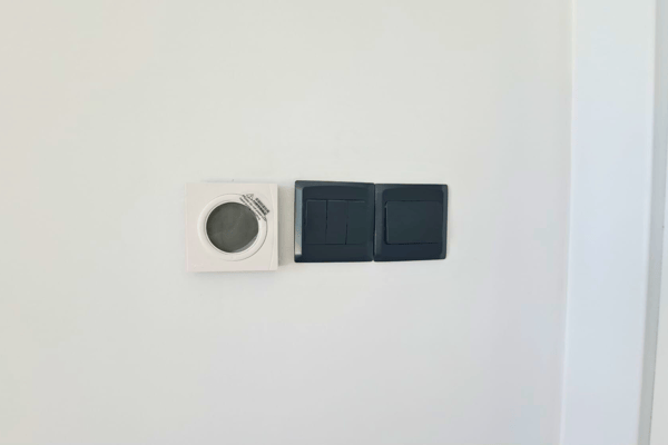 Close-up of modern smart switch panel and wall finishing.