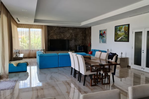 Elegant bedroom in a waterfront villa in Northern Cyprus, featuring a cozy bed, soft lighting, and an ocean-facing private balcony.