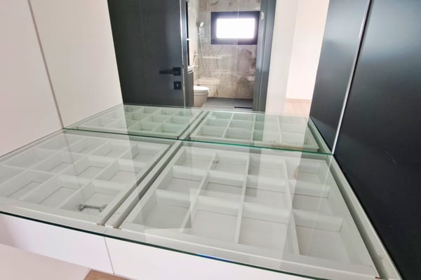 Glass floor panel adds visual interest and spreads natural light between levels, enhancing the modern aesthetic.