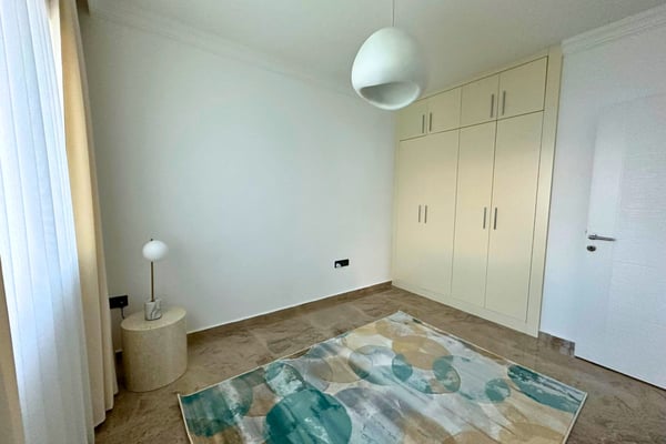 Sunlit transitional space with minimalist decor and cohesive design, connecting seamlessly to surrounding rooms.