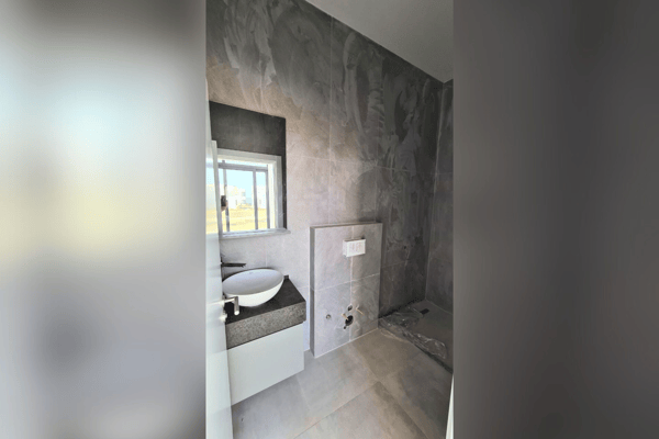 Compact utility area with essential appliances, integrating convenience into the apartment’s thoughtful layout.