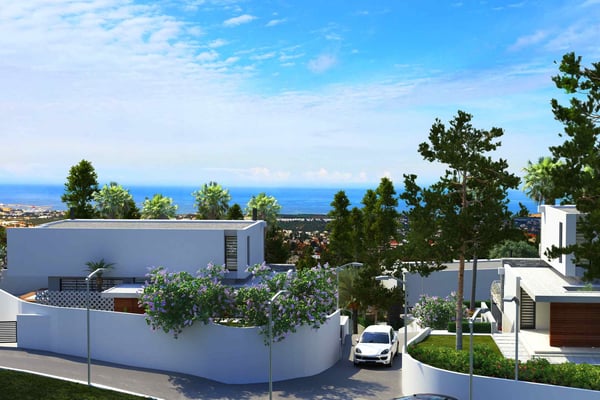 Modern villa with a rooftop terrace, surrounded by lush greenery and offering a sea view