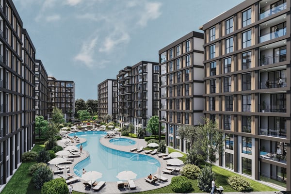 Curved lagoon pool framed by lush landscaping and relaxing seating areas, designed for serene outdoor leisure.