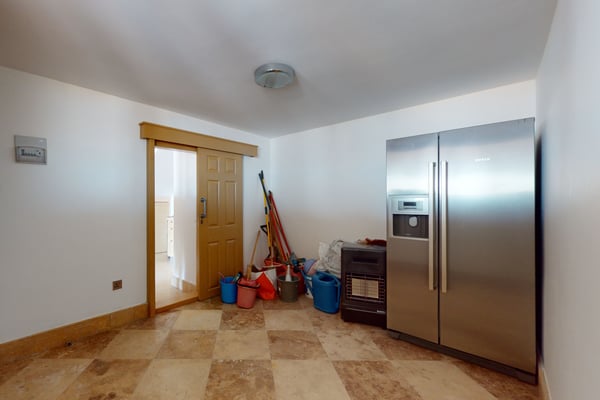 Bright and open entrance hallway featuring a sleek console table, decorative plants, and stylish lighting fixtures.