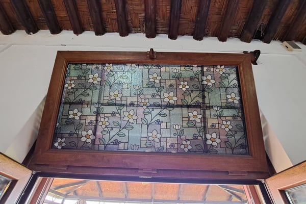 Sunlit stone-paved courtyard – A spacious courtyard with rustic stone tiles, surrounded by lush greenery and traditional architectural details.