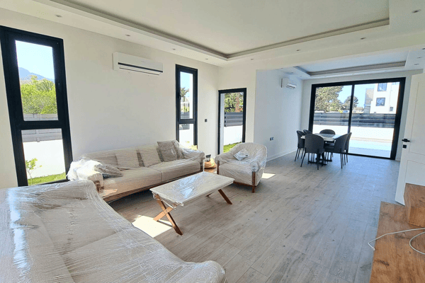 Main lounge area with sectional sofa, accent lighting, and clean architectural lines.