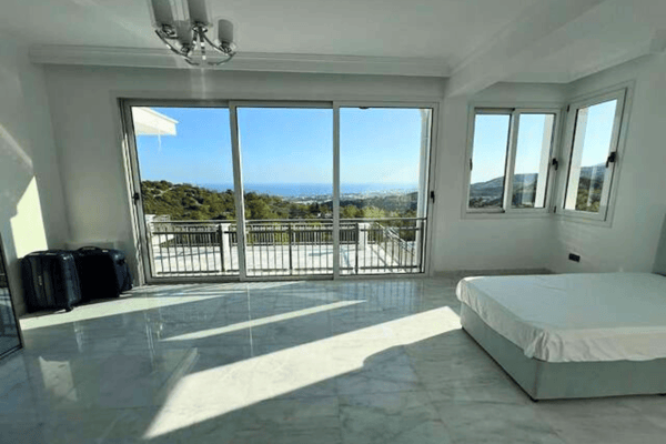 Double twin beds with large windows and daylight streaming in.