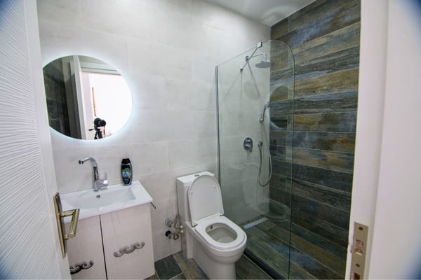 Stylishly appointed bathroom with refined fittings and contemporary layout in a calming palette.