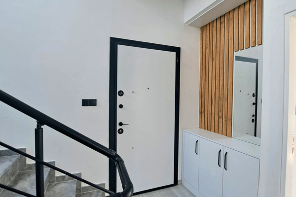 Entry foyer with built-in storage and modern vertical wood detailing.