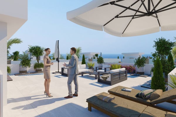 Covered outdoor lounge with rattan seating and sea views, ideal for shaded alfresco entertaining and lounging.