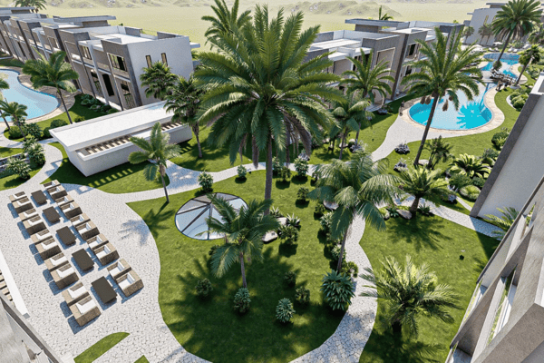 Overhead view showing sunbeds, water features, and organized outdoor spaces, emphasizing community leisure areas.