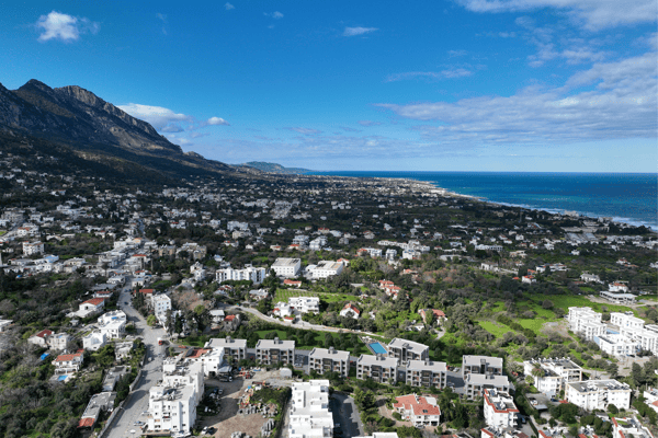 High-altitude image capturing sweeping views of both mountains and the sea, perfectly illustrating the property's scenic placement.
