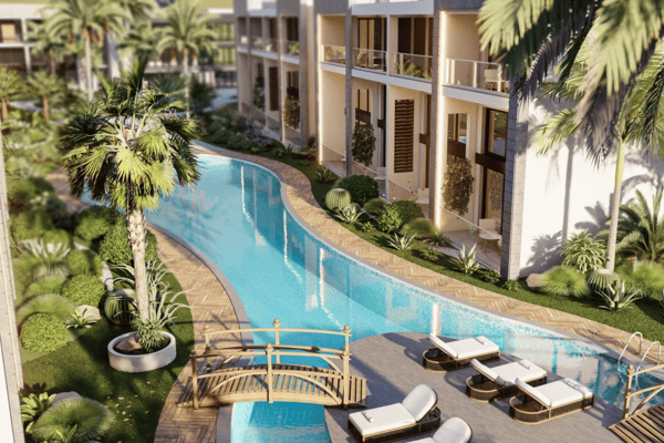 Peaceful waterway pool snaking through palm-lined gardens and minimalist poolside furnishings in a resort atmosphere.