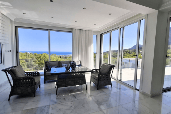 Similar dining room angle with panoramic views from the windows.