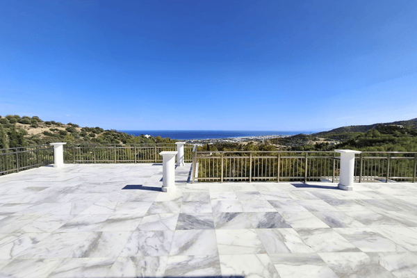 Open marble or tile terrace with balustrade and unobstructed views.